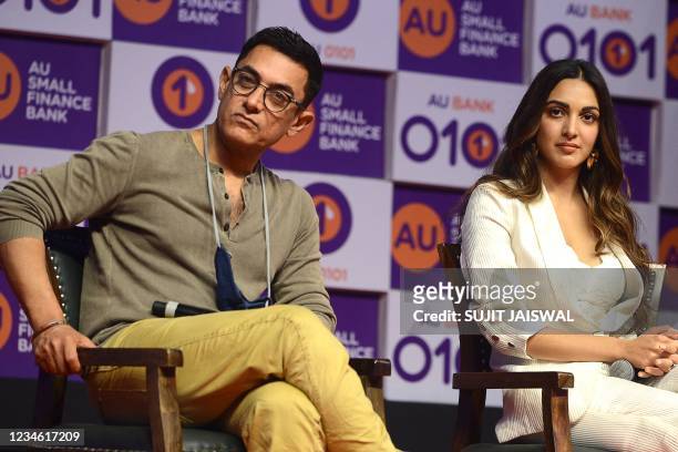 Actors Amir Khan and Kiara Advani participate in an event organised by AU Small Finance Bank in Mumbai on August 11, 2021.