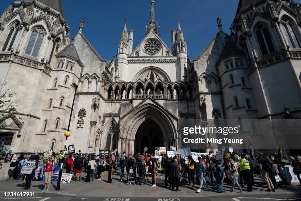 Supporters gather outside as the High Court hears a US appeal in the extradition of WikiLeaks founder Julian Assange, at Royal Courts of Justice,...