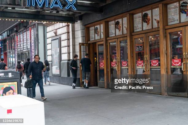 People entering AMC movie theater in Times Square whose parent company AMC Entertainment announced accepting Bitcoins as payment by the end of 2021....