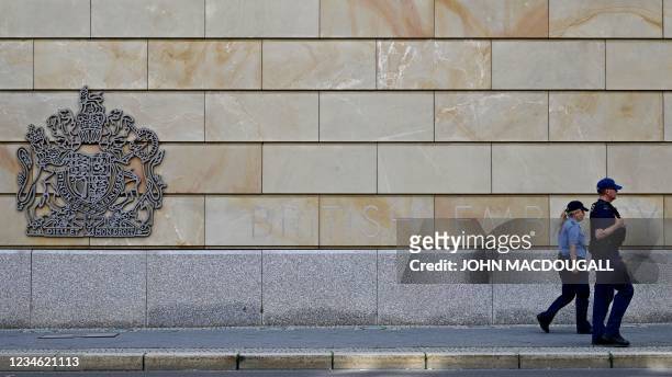 Berlin police officers walk in front of the British Embassy in Berlin on August 11, 2021. - A British man suspected of spying for Russia in exchange...