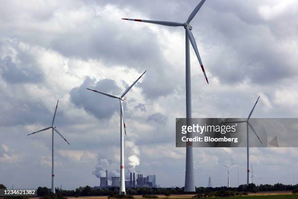 Wind turbines near the Niederaussem coal power plant, operated by RWE AG, in Rheinisches Revier, Germany, on Wednesday, Aug. 11, 2021. A report from...
