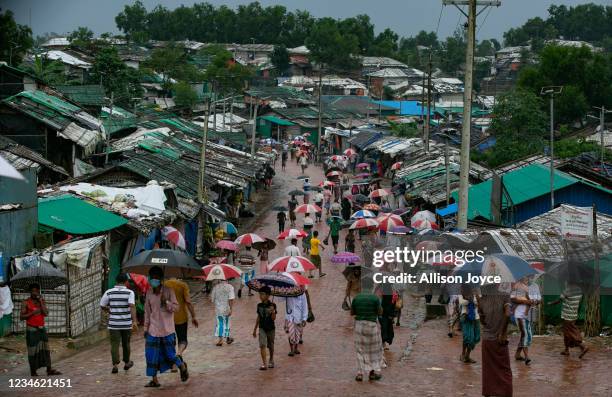 People walk through a road in a Rohingya refugee camp on August 11, 2021 in Cox's Bazar, Bangladesh. On Tuesday, Bangladesh started a COVID-19...