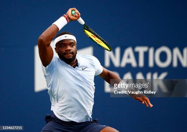 Frances Tiafoe of the United States hits a shot against Denis Shapovalov of Canada during the second round on Day Three of the National Bank Open at...