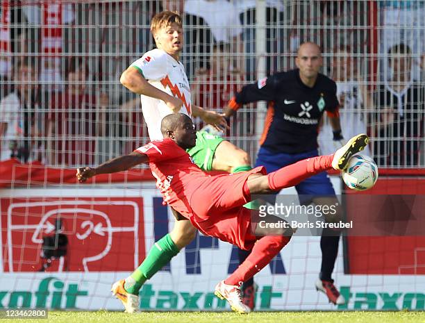 John Jairo Mosquera of Berlin kicks for the ball in front of Sebastian Proedl of Bremen during the Season Friendly match between Union Berlin and...