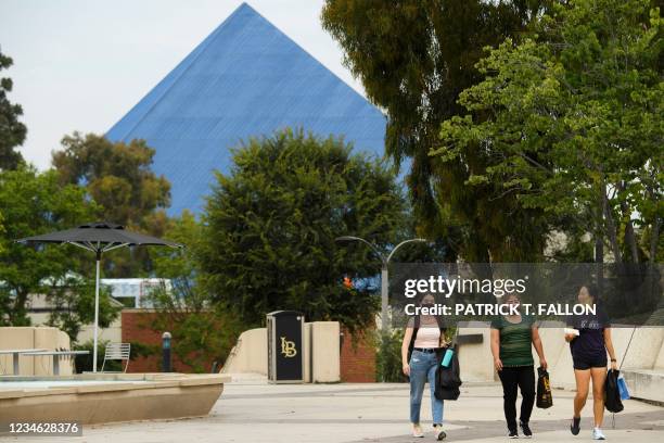 People walk on the California State University Long Beach campus before the return of students for Fall classes on August 11, 2021 in Long Beach,...