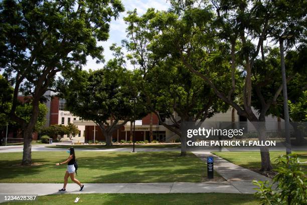 Person walks on the California State University Long Beach campus before the return of students for Fall classes on August 11, 2021 in Long Beach,...