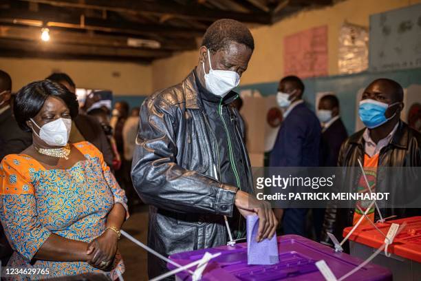 Zambia's incumbent president Edgar Lungu casts his vote at a polling station in Lusaka on August 12 as they country holds presidential and...