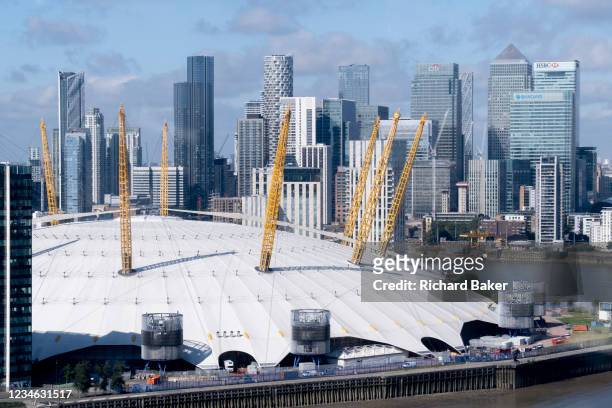 An aerial view from an Emirates Air Line cable car of showing the O2 Arena on the Greenwich Peninsular and the distant London Docklands, on 11th...