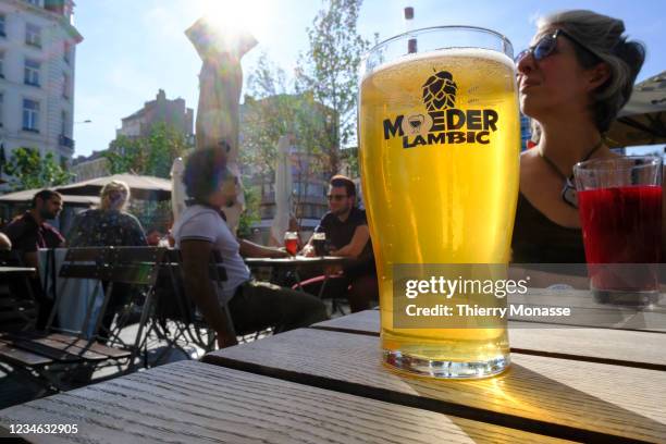 People enjoy the 'Moeder Lambic' terrace at Place Fontainas on August 11, 2021 in Brussels, Belgium. Due to the new Covid-19 pass in France, many...