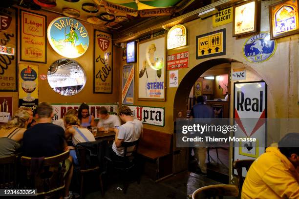 People enjoy a summer evening in the 'Delirium Café Brussels, a famous tourist pub in the Ilot Sacre on August 11, 2021 in Brussels, Belgium. The...
