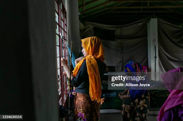 Rohingya refugees who are suspected to be suffering from COVID-19 are seen in a hospital in a Rohingya refugee camp on August 12, 2021 in Cox's...