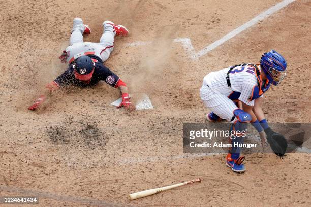 Gerardo Parra of the Washington Nationals scores a run behind James McCann of the New York Mets during the seventh inning in game two of a...