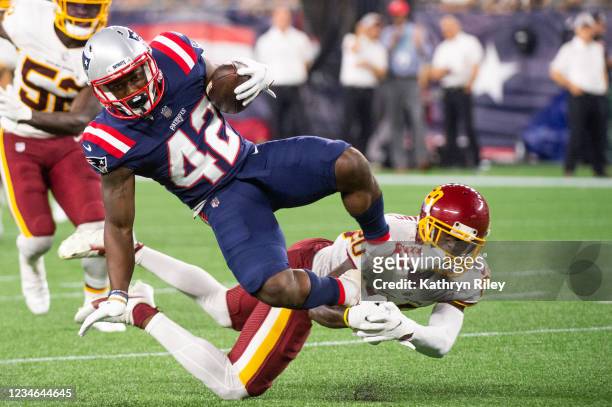Taylor of the New England Patriots controls the ball against Jimmy Moreland of the Washington Football Team in the first half at Gillette Stadium on...