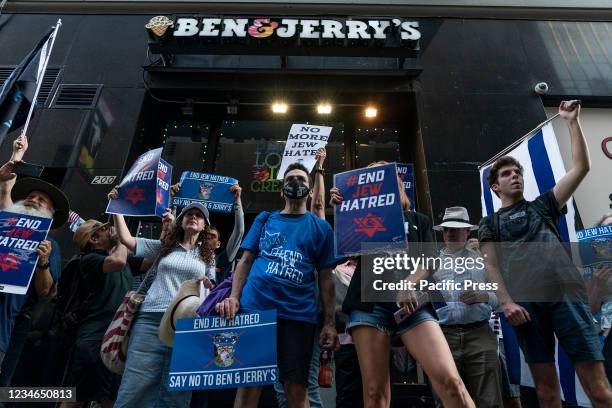 Protesters staged a rally on the steps of New York Public Library and marched to Ben & Jerry's store in Times Square to continue the rally against...