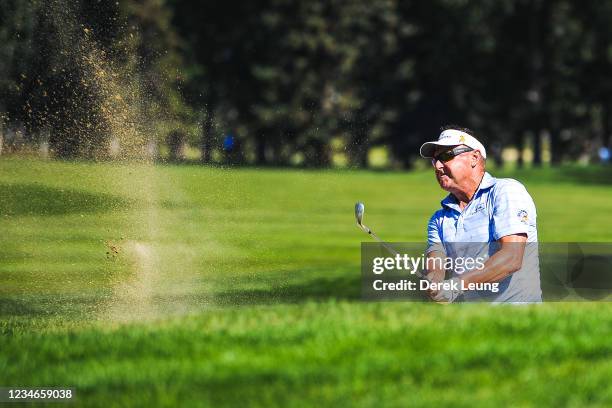 Robert Allenby of Australia shoots out of the sand during round one of the Shaw Charity Classic at Canyon Meadows Golf & Country Club on August 13,...