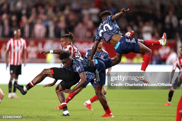 Ivan Toney of Brentford battles with Albert Lokonga of Arsenal and Nuno Tavares of Arsenal during the Premier League match between Brentford and...
