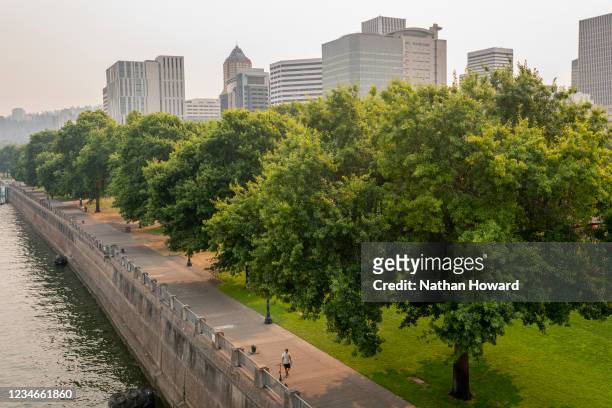 Wildfire smoke lingers over Downton, keeping heatwave temperatures relatively low, on August 13, 2021 in Portland, Oregon. As temperatures climb...