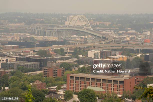 Wildfire smoke lingers over the downton area, keeping heatwave temperatures relatively low, on August 13, 2021 in Portland, Oregon. As temperatures...