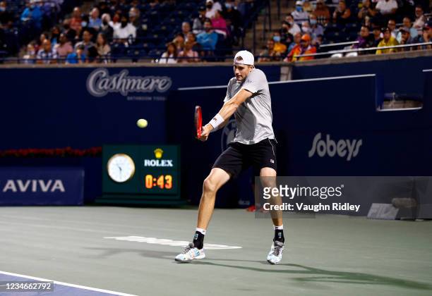 John Isner of the United States hits a shot against Gael Monfils of France during a quarterfinal match on Day Five of the National Bank Open at Aviva...