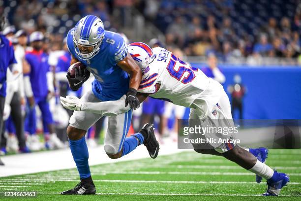 Andre Smith of the Buffalo Bills tackles Tyrell Williams of the Detroit Lions during the first quarter of a preseason game at Ford Field on August...