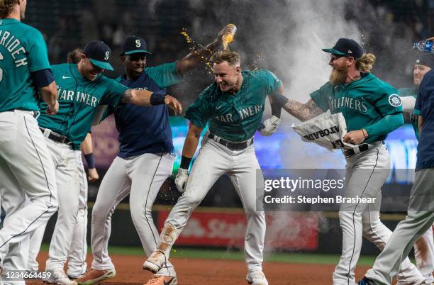 Jarred Kelenic of the Seattle Mariners celebrates a walk off walk with teammates including Justin Duinn and Jake Fraley after a game against the...
