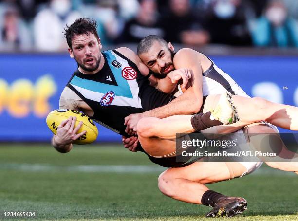 Travis Boak of the Power is tackled by Adam Saad of the Blues during the 2021 AFL Round 22 match between the Port Adelaide Power and the Carlton...