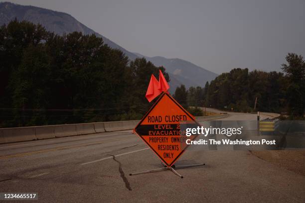 Road closure and evacuation sign on Highway 20 between Winthrop and Mazama, Wash., where the Cedar Creek and Cub Creek 2 wildfires are threatening...