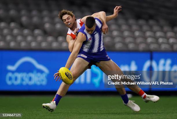 Luke Davies-Uniacke of the Kangaroos and Dane Rampe of the Swans compete for the ball during the 2021 AFL Round 22 match between the North Melbourne...