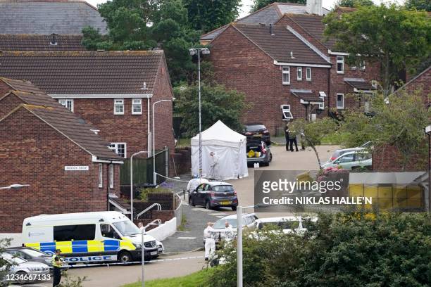Police officers and memers of the forensics team work at the scene of a shooting incident in Plymouth, southwest England, on August 14, 2021. -...
