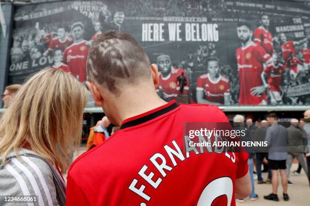 Fan sports the devil symbol of Manchester United's logo as part of his haircut ahead of the English Premier League football match between Manchester...
