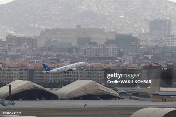 This picture taken on August 14, 2021 shows an Ariana Afghan Airlines aircraft taking-off from the airport in Kabul.