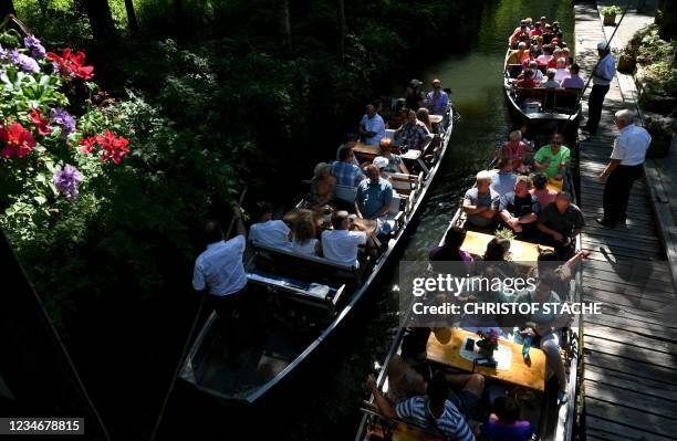 Tourists enjoy a boat trip through the biosphere reserve Spreewald on a warm summer day near the small village of Luebbenau in Brandenburg, eastern...