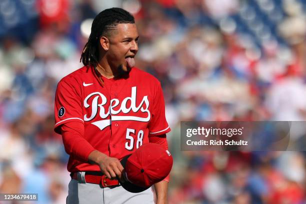 Pitcher Luis Castillo of the Cincinnati Reds sticks his tongue out after walking off the mound against the Philadelphia Phillies during a game at...