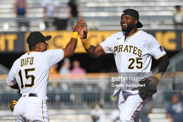 Gregory Polanco of the Pittsburgh Pirates high fives with Wilmer Difo after the final out in a 14-4 win over the Milwaukee Brewers during Game One of...