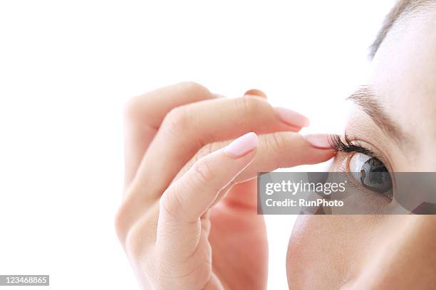 young woman touching around the eyes,close-up - maquillaje para ojos fotografías e imágenes de stock