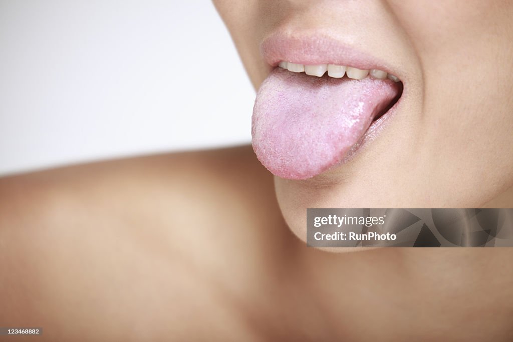 Young woman sticking out tongue, close-up