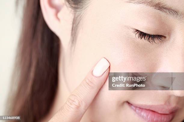 young woman touching blush,close-up,beauty care - finger studio close up ストックフォトと画像