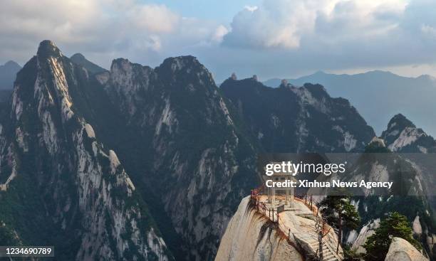 Aerial photo taken on Aug. 14, 2021 shows the mist-shrouded Mount Huashan in Weinan City, northwest China's Shaanxi Province.