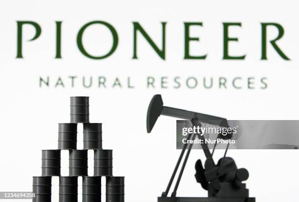 Pioneer Natural Resources Company logo and miniature models of an oil derrick pump and oil barrels are pictured in this illustration photo taken in...