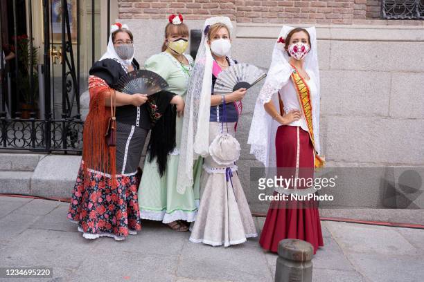 Women dressed in the typical costume of Chulapas attend a Eucharist on the occasion of the day of the Virgen de la Paloma, on August 15, 2021 in...