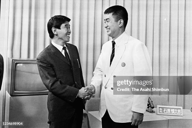 Newly elected Upper House lawmakers Shintaro Ishihara and Yukio Aoshima shake hands on July 8, 1968 in Tokyo, Japan.