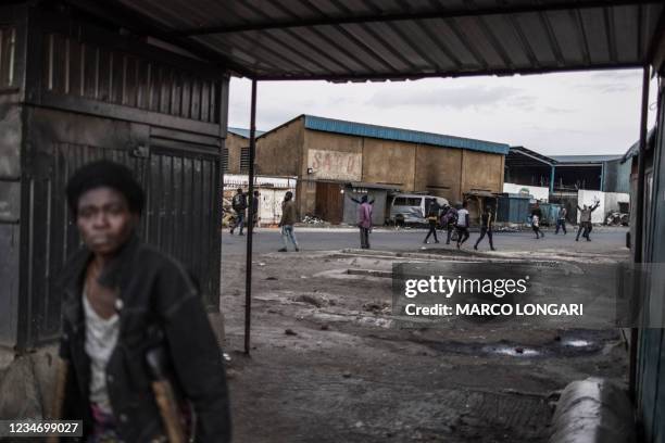 Woman crosses an underpass as supporters of Zambian presidential candidate for the opposition party United Party for National Development Hakainde...