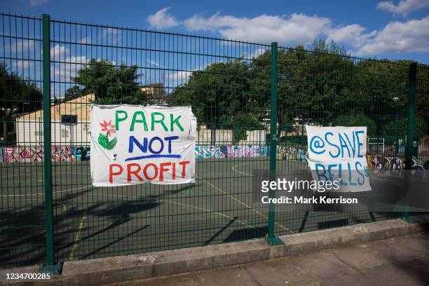 Banners prepared by local residents and campaigners are displayed on fencing around sports facilities at Bells Gardens in Peckham on 14th August 2021...
