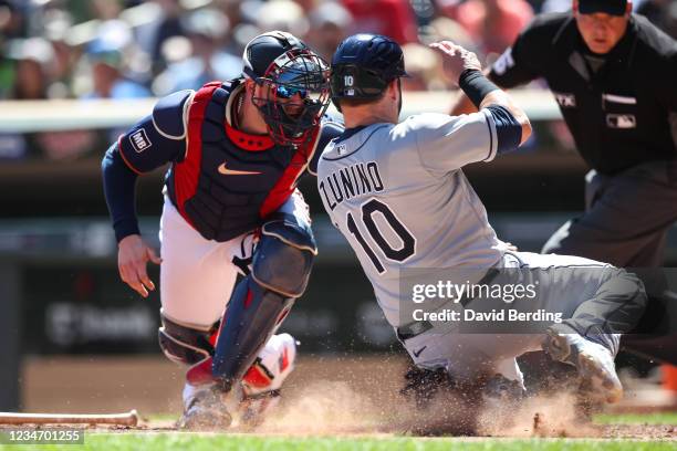 Mitch Garver of the Minnesota Twins tags out Mike Zunino of the Tampa Bay Rays at home plate on a fielder's choice in the third inning of the game at...