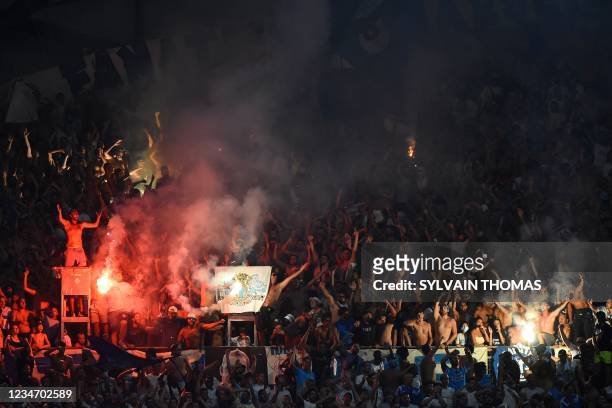 Marseille's supporters light flares during the French L1 football match between Olympique de Marseille and FC Girondins de Bordeaux at The Stade...