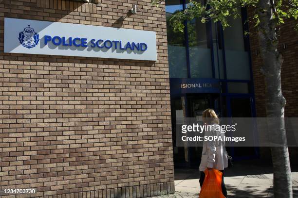 Woman walks past a police station in Edinburgh, Scotland.