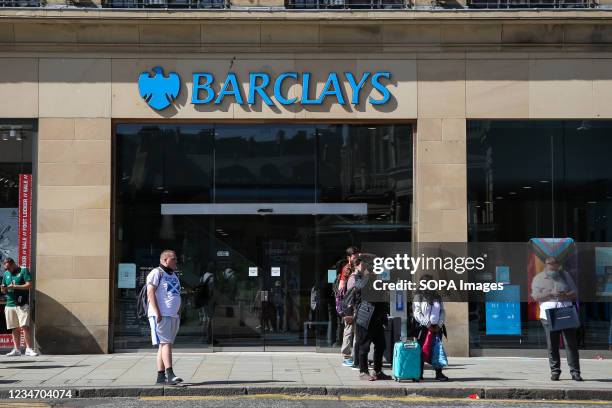 People walk past a branch of Barclays Bank in Edinburgh, Scotland.