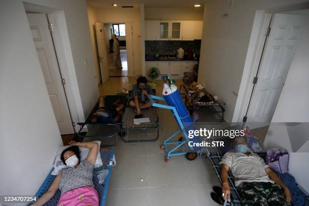 This photograph taken on August 8, 2021 shows Covid-19 coronavirus patients receiving oxygen in a make-shift ward at the Field Hospital Number 6 in...