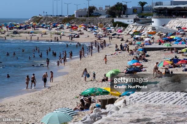 People sunbathe on Figueira da Foz beach during the COVID-19 pandemic, on August 15, 2021 in Figueira da Foz, Portugal. People sunbathe on Figueira...