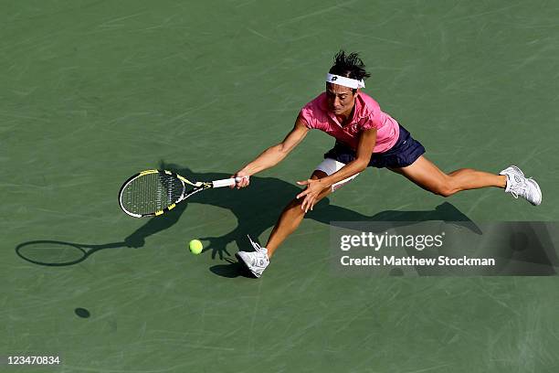 Francesca Schiavone of Italy returns a shot against Chanelle Scheepers of South Africa during Day Six of the 2011 US Open at the USTA Billie Jean...